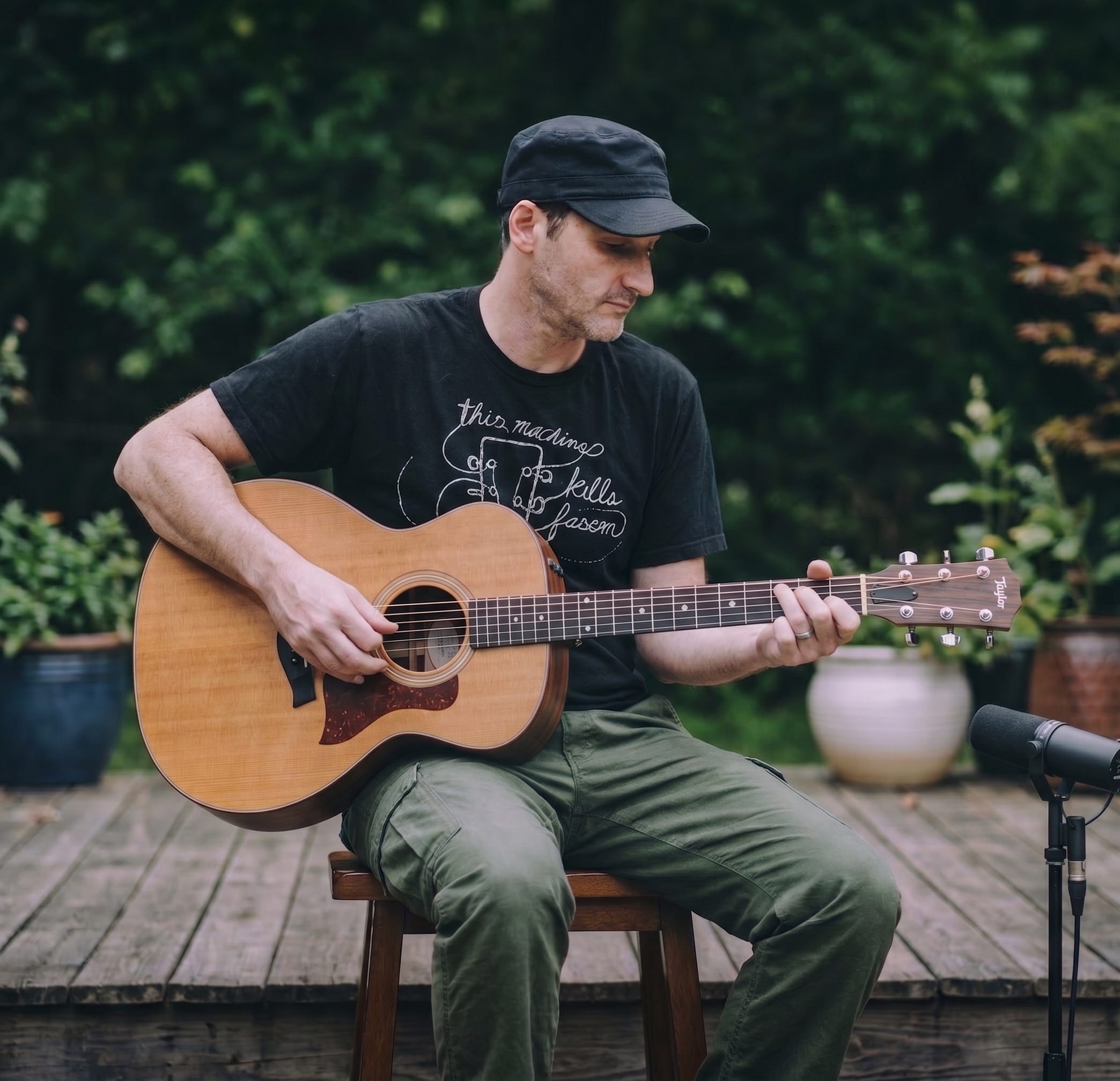Marcus Crutcher seated with acoustic guitar on an outdoor stage